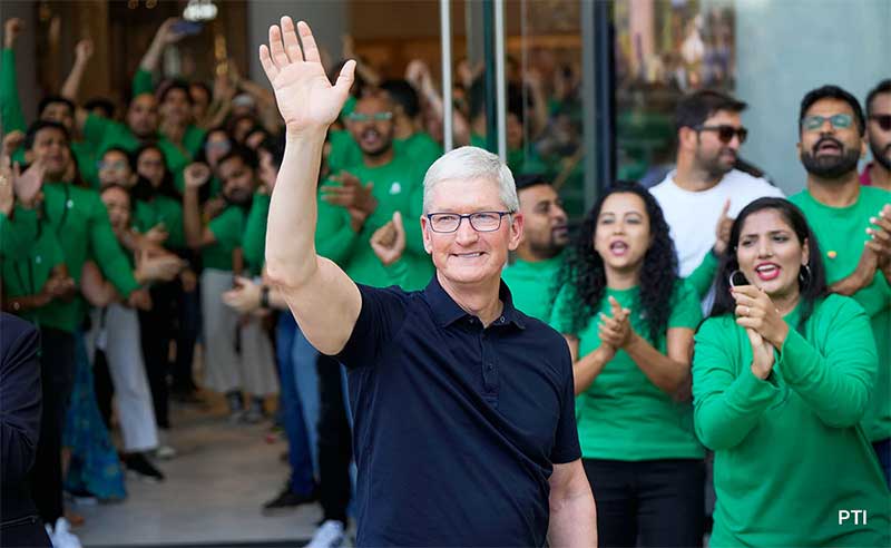 Tim Cook waiving towards people gathered for opening ceremony 
